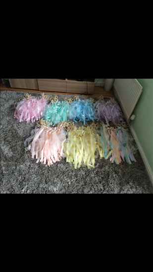 Pastel ribbon and lace chair decorations, paper lanterns and other lovely wedding bits