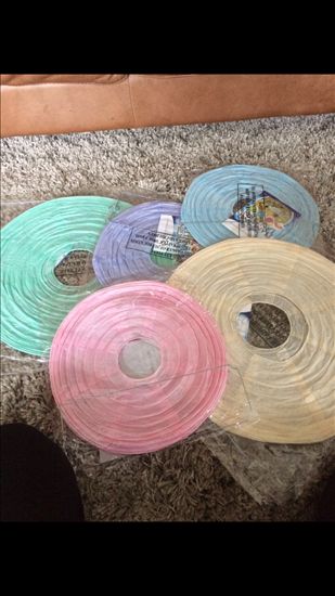 Pastel ribbon and lace chair decorations, paper lanterns and other lovely wedding bits