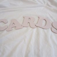 Pale pink wooden 'CARDS' letters