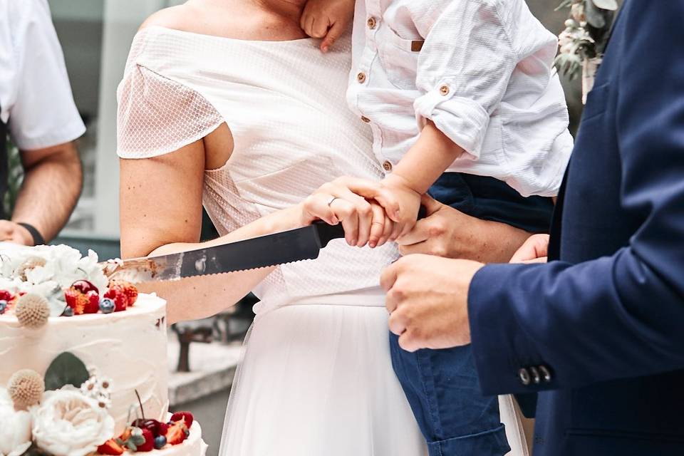 A family cutting the cake