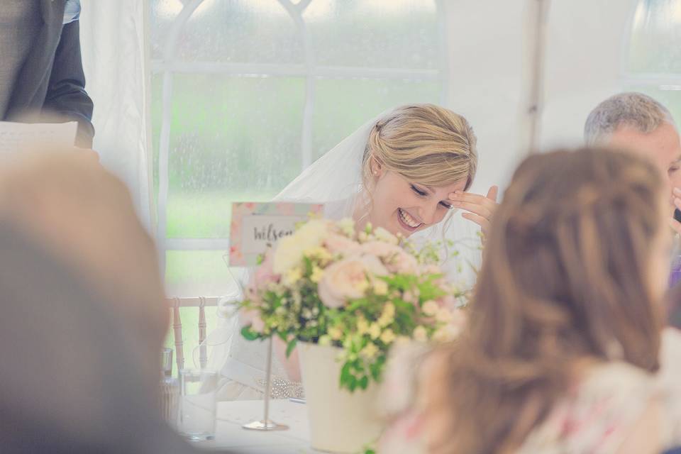 Bride laughing at speeches