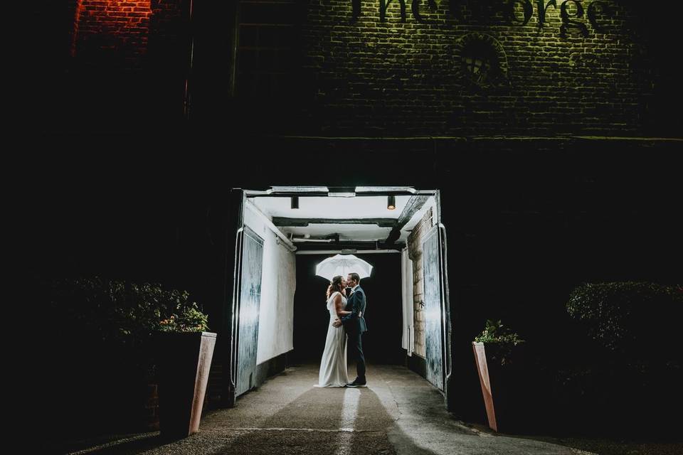 Couple standing under an umbrella