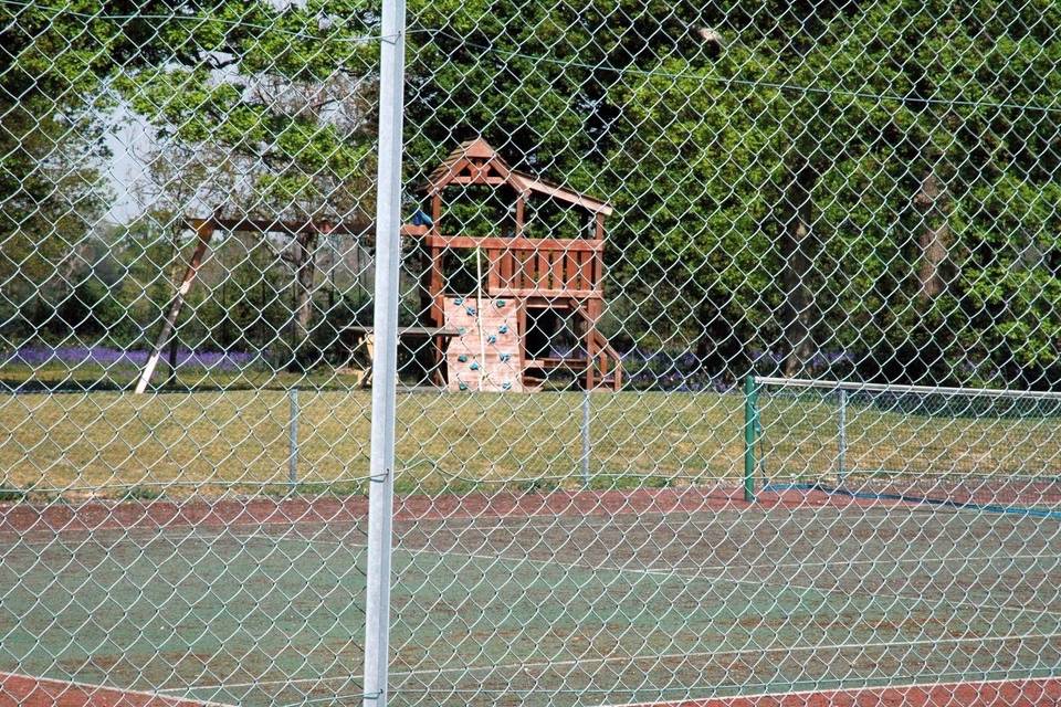 Tennis court & play area.