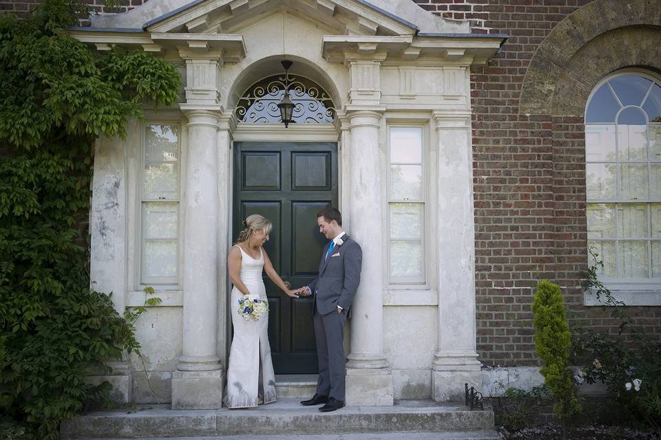 bride and groom look at ring