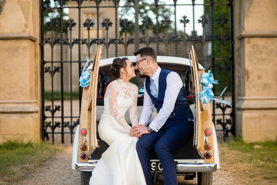 Pair seated on the wedding car - Laura Ellen Photography