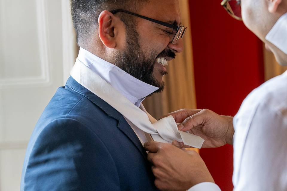 Groom having help with his tie