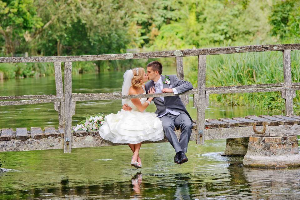 Newlyweds sitting on a bridge - Paul Burrows Photography