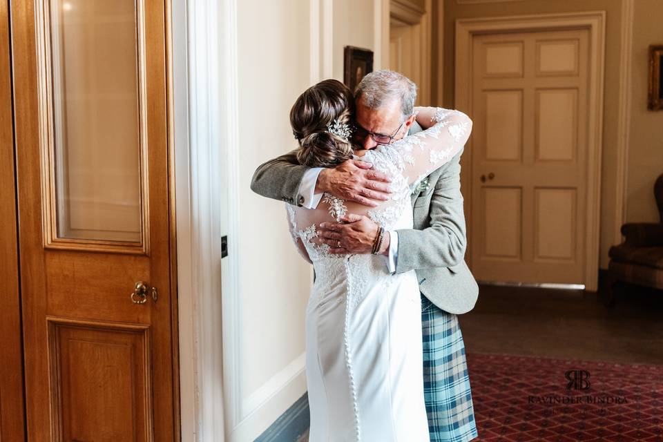 Dad and bride hug