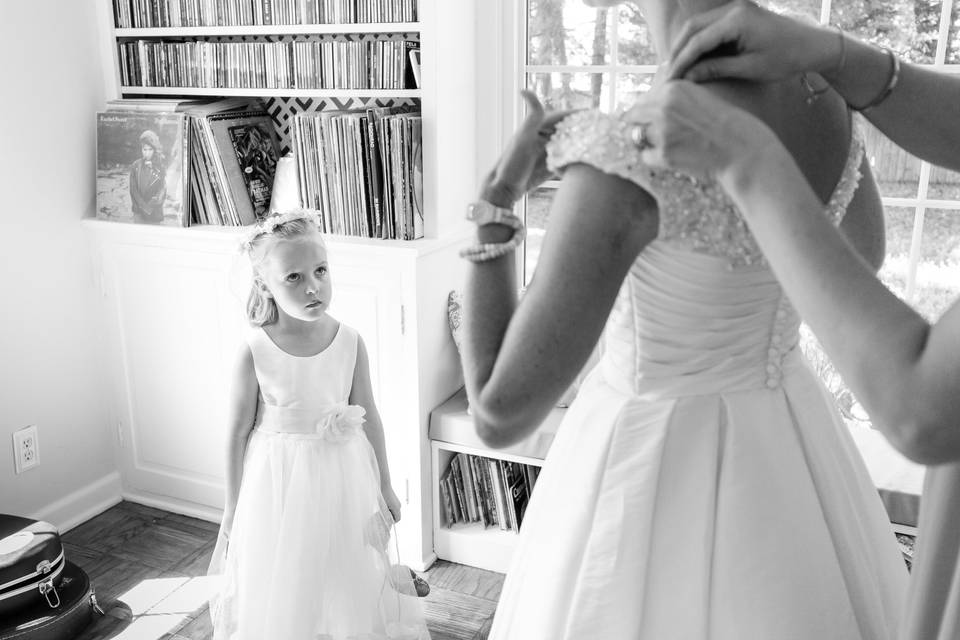 Bridesmaid watches bride dress