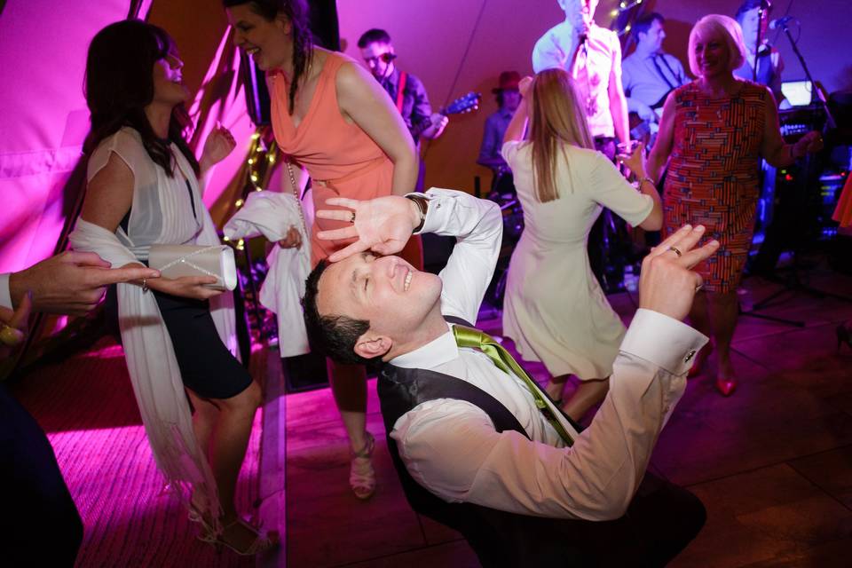 Groom dancing on dancefloor