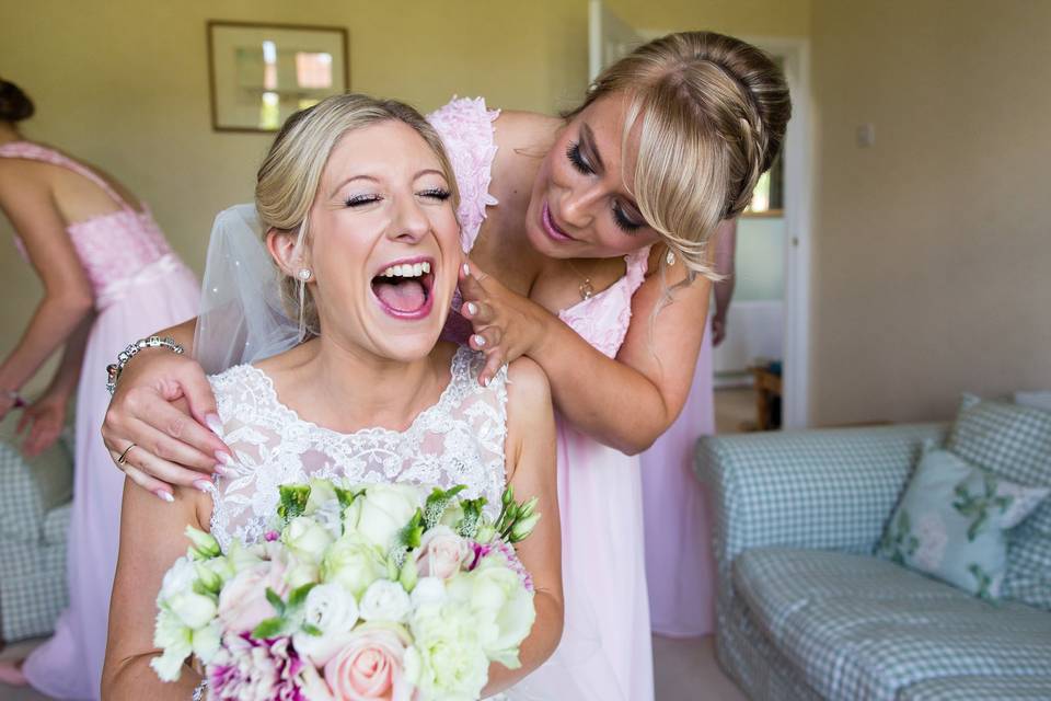 Bride smiles with sister