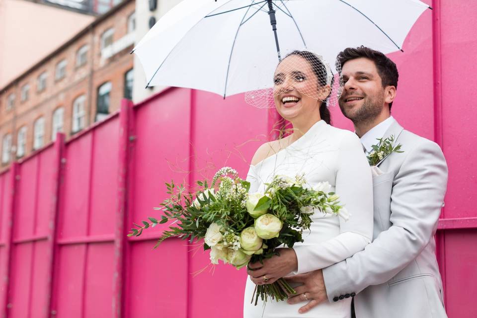 Bride and groom under an umbrella