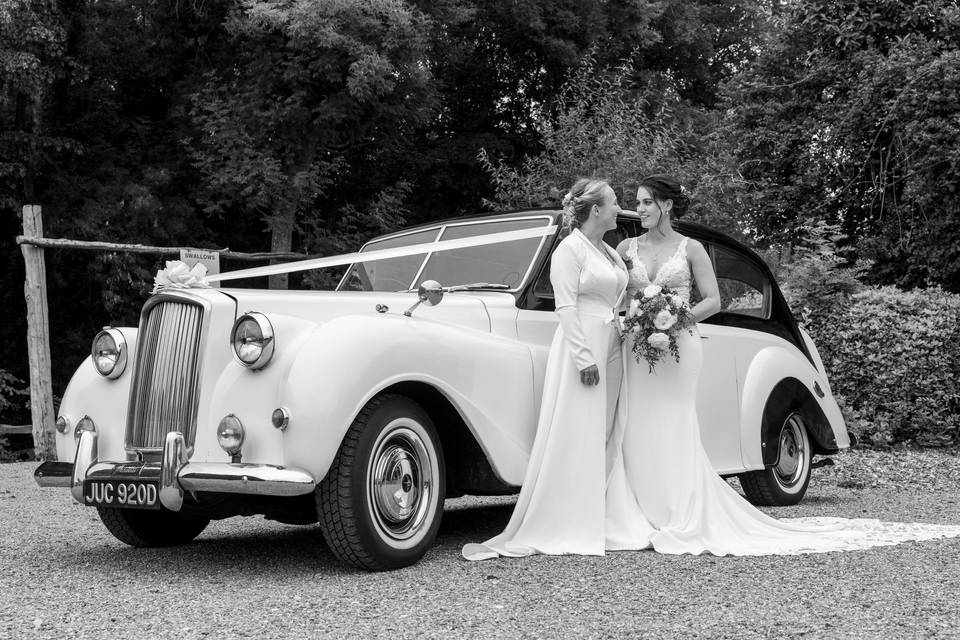 The happy couple by their car