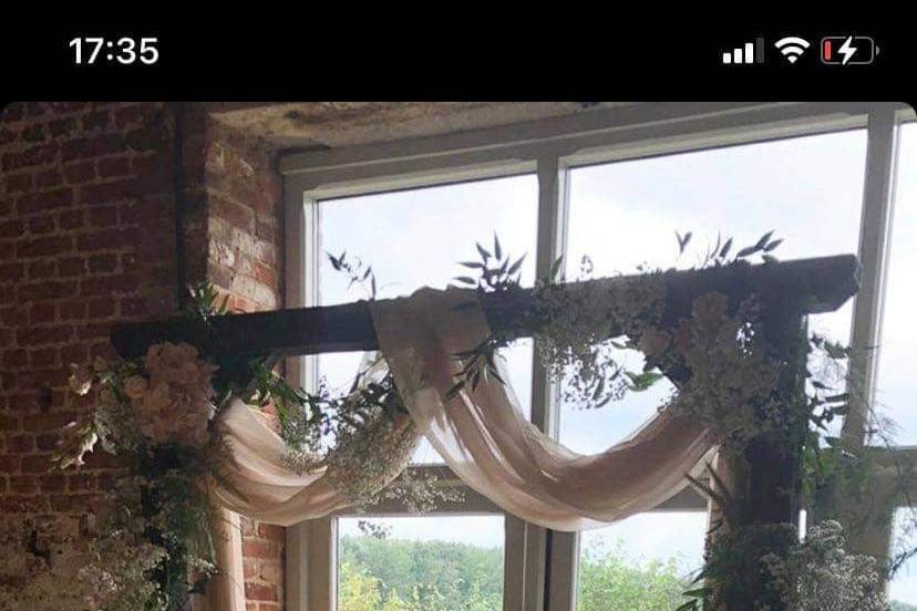 Rustic arch with blush drape