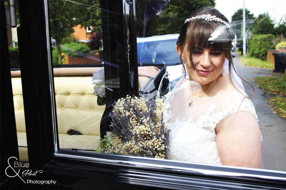 Bride enters her wedding car
