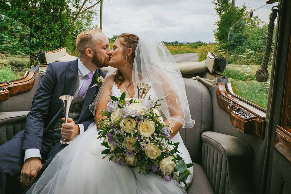 Married couple kiss in car