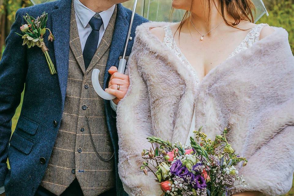 Bride and groom with umbrella