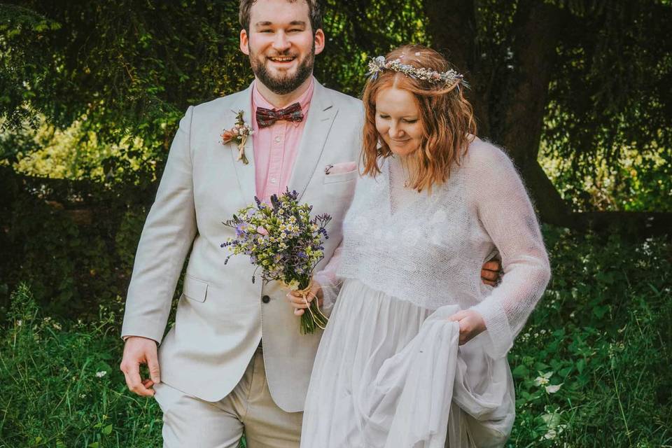 Bride and groom in long grass