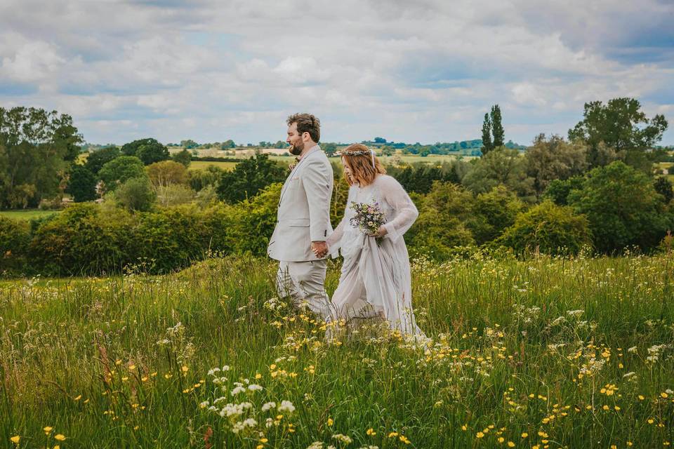 Bride and groom in meadow