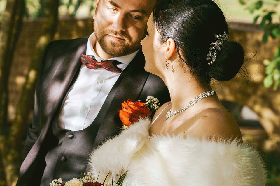 Bride and groom stand in shade