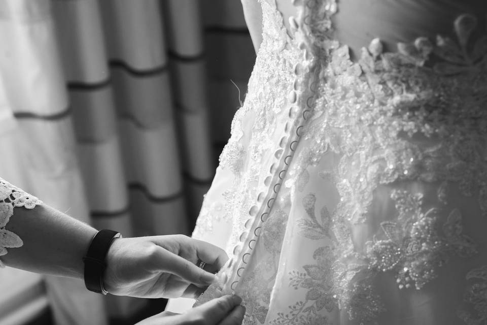 Wedding dress being fastened