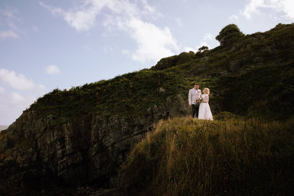 Bride and groom on cliff edge