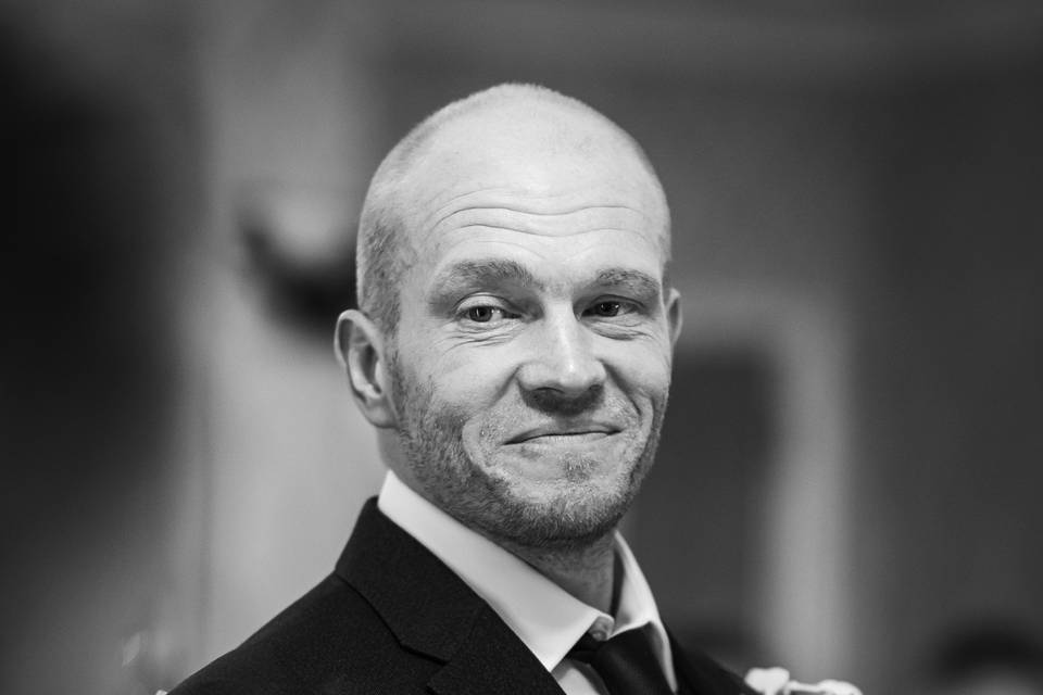 Groom smiles during ceremony