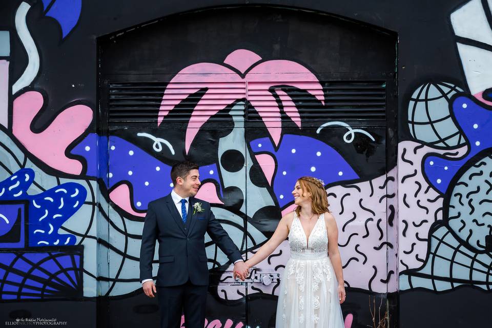 Newlyweds with city mural