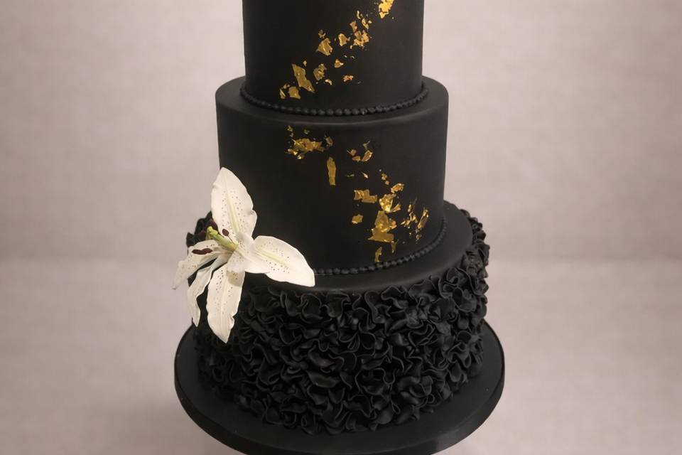 Black and gold ruffle cake