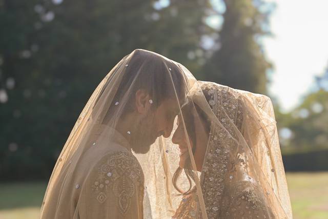 Bride and groom under veil