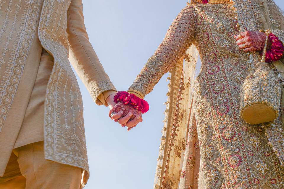Bride and groom holding hands