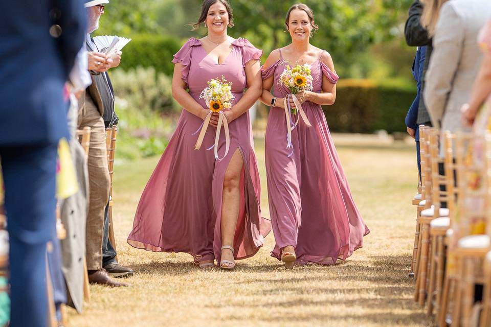 Bridesmaids walking down isle