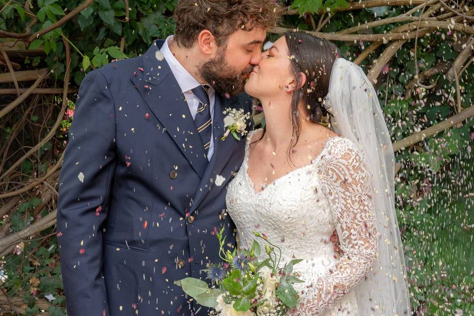 Bride and groom under confetti