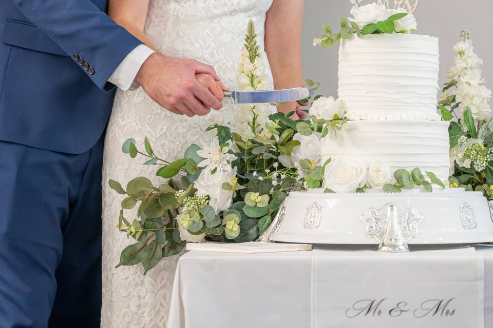 Bride and groom cutting cake