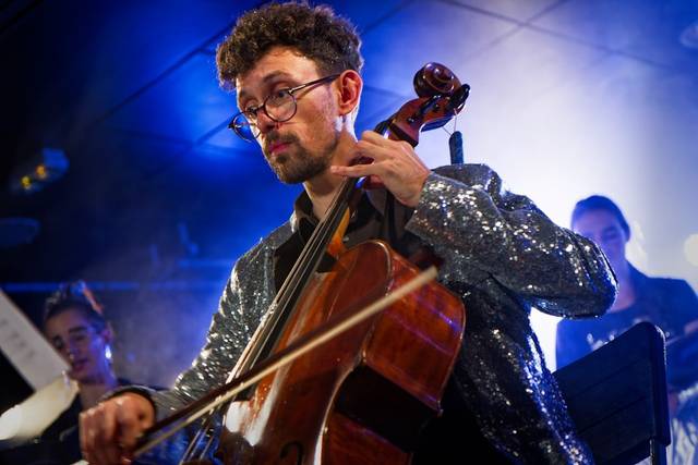 A cellist playing a pop concer