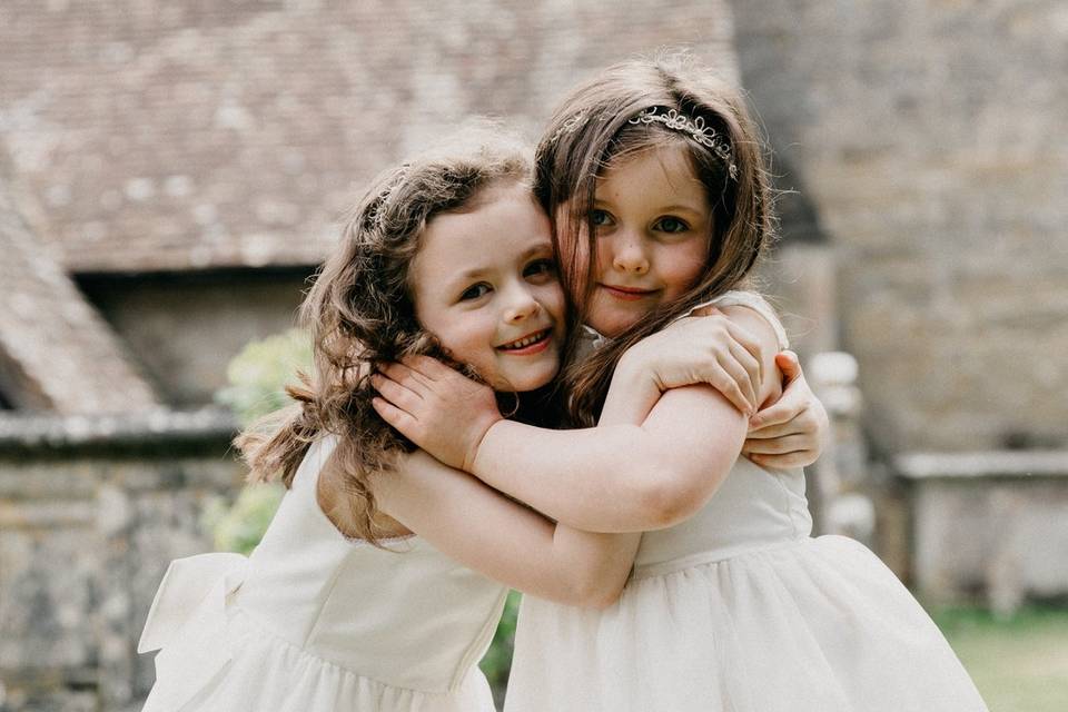 Flower girls hugging each other