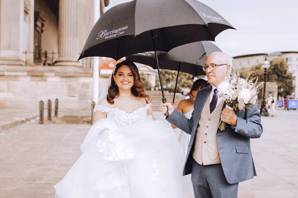 Bride in rain with dad