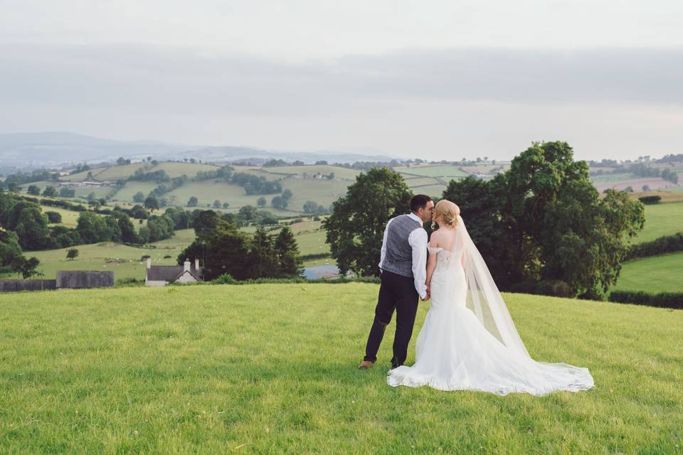 Couple kiss on hillside