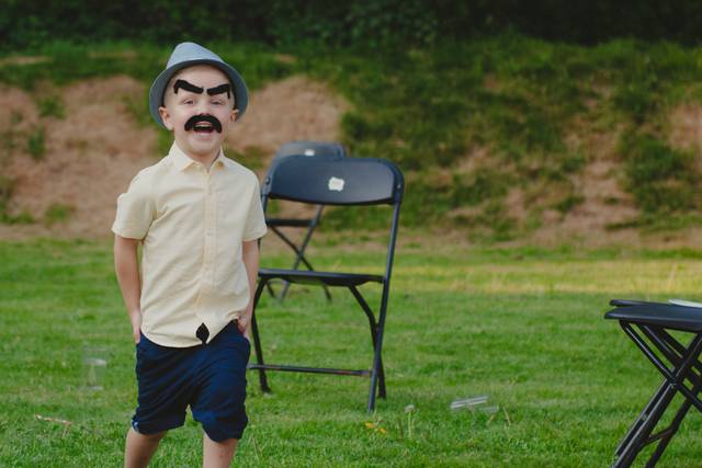 Little boy has fake moustache
