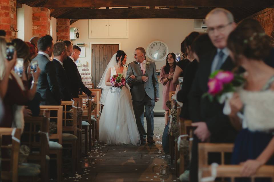 Bride and dad walk down aisle
