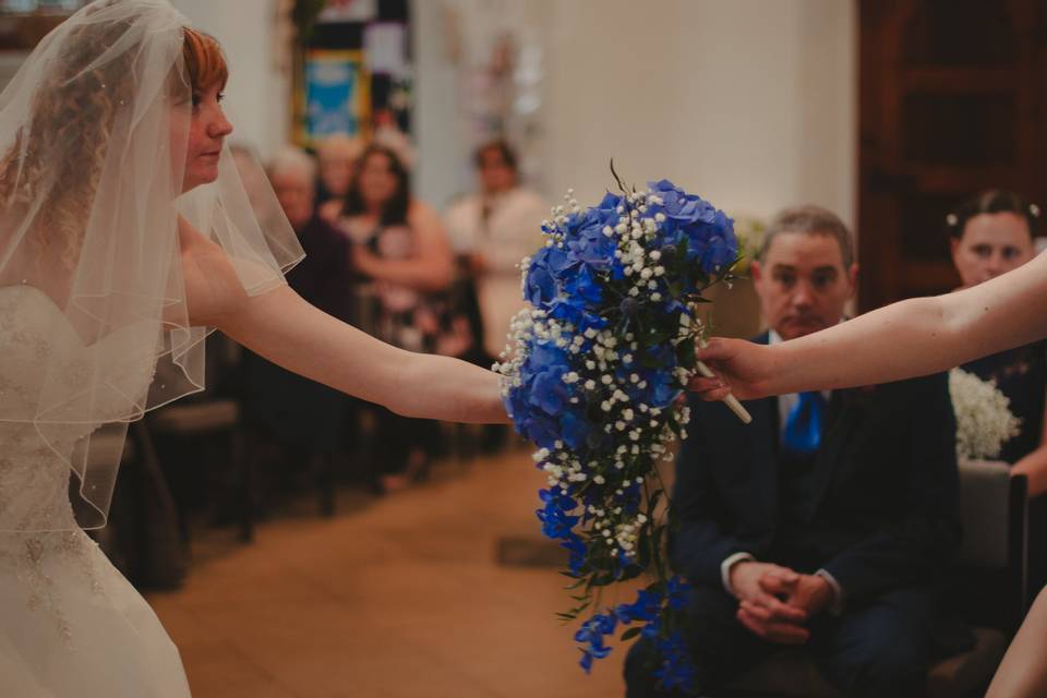 Bride passes bouquet