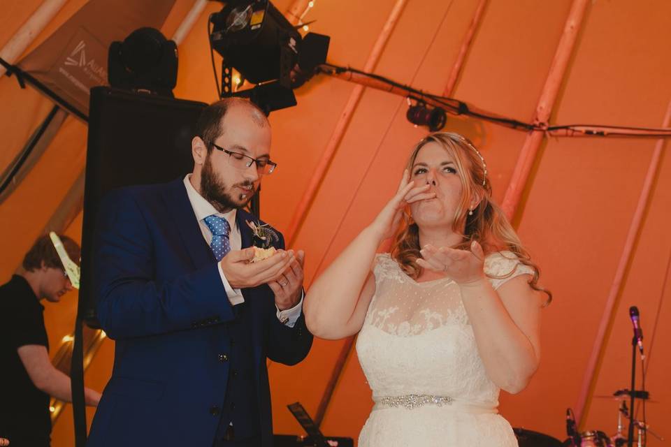 Bride and groom lick fingers