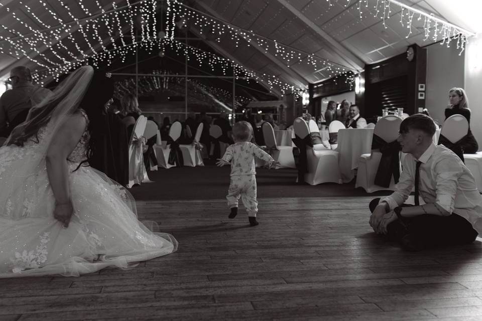 Bride and child dancing