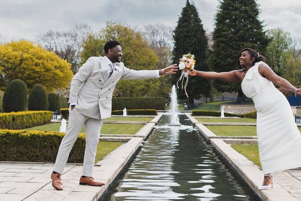Groom Handing Bouquet to Bride