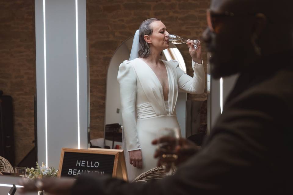 Bride drinking champagne.