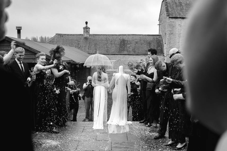 Confetti wedding exit in rain