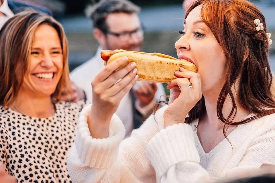 Bride eating hot dog