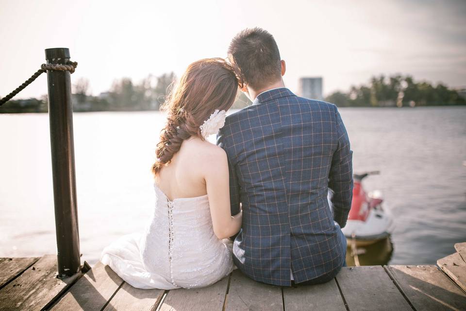 Couple seated by the water