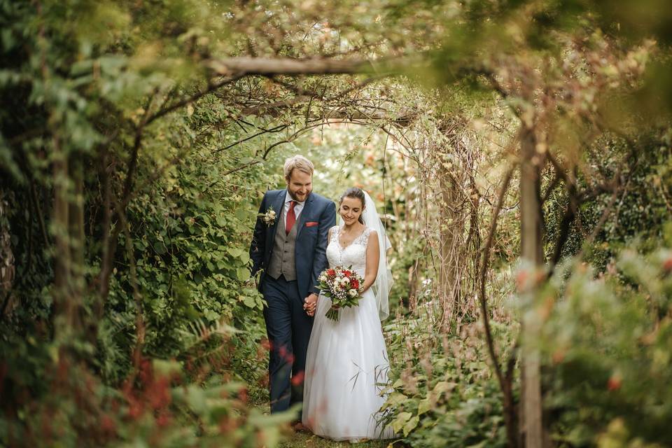 Newlyweds holding hands - Blue Lily Weddings