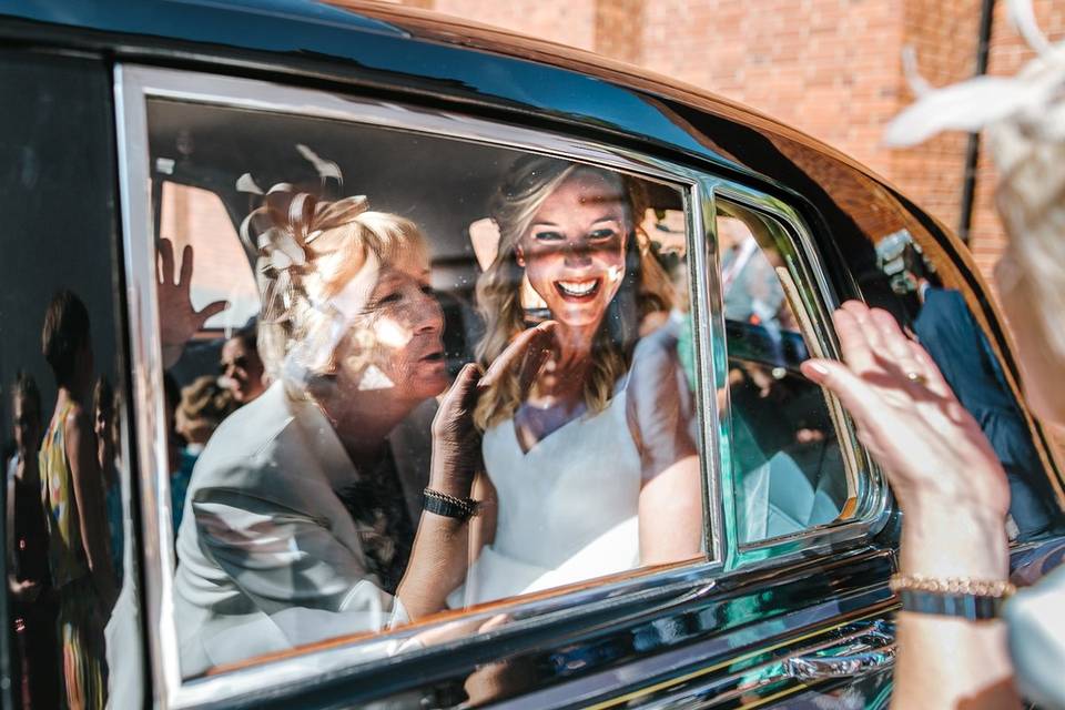 Newlyweds in the wedding car - Blue Lily Weddings